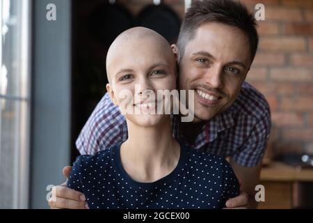 Ritratto di felice giovane abbracciando amata donna con cancro Foto Stock