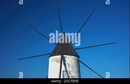 particolare di un vecchio mulino a vento con pale su cielo blu Foto Stock