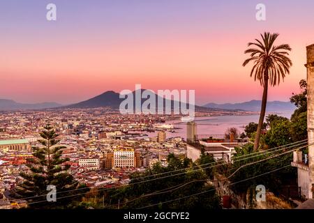 Napoli, Italia - 11 luglio 2021: Baia di Napoli e vulcano Vesuvio in background al tramonto in una giornata estiva in Italia, Campania Foto Stock