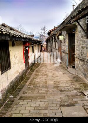 Un antico vicolo con una strada di pietra di ciottoli e vecchie mura in gesso casa nel bellissimo antico Lizhuang Foto Stock