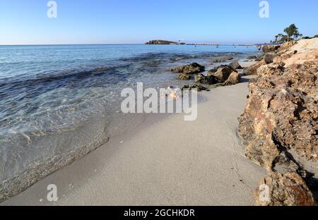 Bella baia di mare Meditteranean puro e spiaggia di Nissi, serpente e rocce, destinazione di vacanza, Cipro. Foto Stock