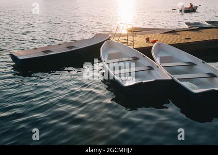 molo in legno e yacht sul grande lago all'alba. Foto Stock