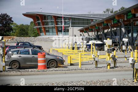 Surrey, Canada. 9 agosto 2021. I veicoli si allineano per entrare in Canada all'attraversamento del confine dell'arco della Pace a Surrey, British Columbia, Canada, il 9 agosto 2021. Il Canada ha iniziato unilateralmente a consentire l'ingresso da parte di cittadini statunitensi e residenti permanenti completamente vaccinati lunedì dopo che i due paesi hanno accettato di chiudere il confine a viaggi non essenziali a causa della pandemia COVID-19 17 mesi fa. Credit: Liang Sen/Xinhua/Alamy Live News Foto Stock