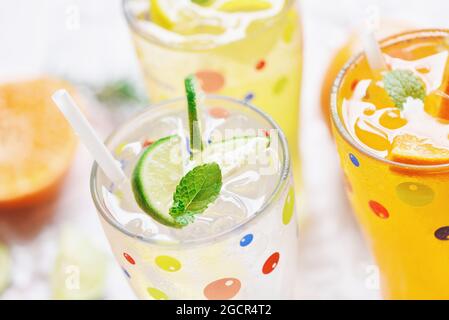 Esotiche bevande estive rinfrescante varietà di bicchieri di bevande fredde frutta fresca su ghiaccio tè fatto in casa cocktail con mojito limone lime arancio rosmarino e min Foto Stock