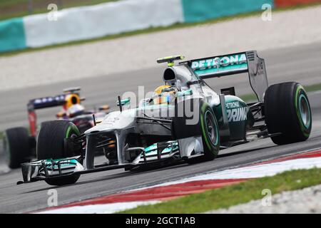 Lewis Hamilton (GBR) Mercedes AMG F1 W04 guida Sebastian Vettel (GER) Red Bull Racing RB9. Gran Premio della Malesia, venerdì 22 marzo 2013. Sepang, Kuala Lumpur, Malesia. Foto Stock