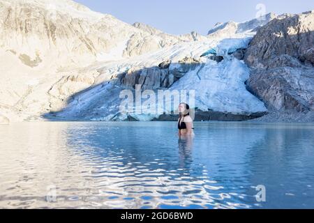 Avventurosa donna bianca caucasica Adult Swimming nel lago ghiacciato Glacier Foto Stock