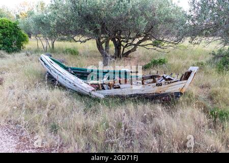 Rotta, vecchia barca da pesca a sinistra per marciare sul lato della strada di campo Foto Stock