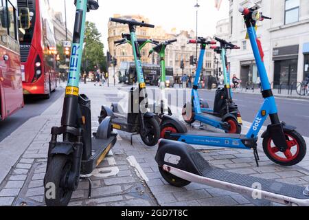 Molti e-scooters per il noleggio a Londra Trafalgar Square Inghilterra UK Foto Stock