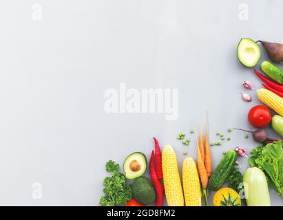 Piatto con verdure diverse, frutta, bacche, noci, spezie, erbe, olio d'oliva. Area di spazio per la copia di alcuni testi. Veggies su sfondo grigio di cemento Foto Stock