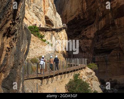 Malaga, Andalusia, Spagna. 09,03,2020. Gruppo di escursionisti con casco e maschere che camminano lungo il Caminito del Rey nella Gola di Gaitanes a Malaga. Foto Stock