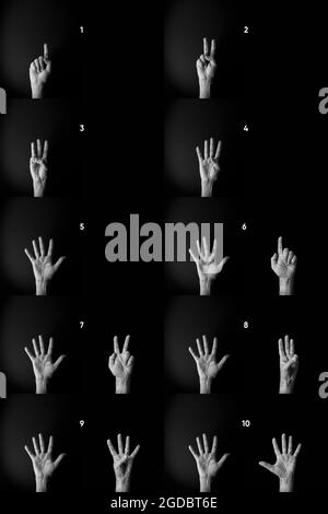 Drammatica immagine in bianco e nero delle mani maschili che mostra i numeri del linguaggio dei segni da uno a dieci su sfondo nero con spazio di copia vuoto per gli editori Foto Stock