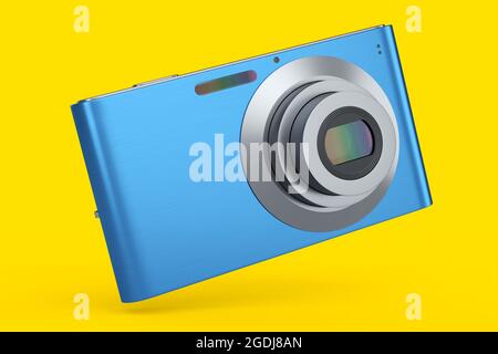 Elegante fotocamera digitale tascabile compatta blu isolata su sfondo giallo. Concetto di destinazione di viaggio in vacanza con rendering 3D Foto Stock