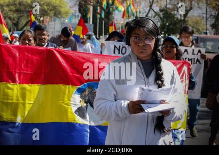 Cochabamba, Bolivia. 13 Agosto 2021. Una giovane donna fornisce "schede informative" durante un raduno tenuto in mezzo alla pandemia di Corona sotto lo slogan "protesta nazionale per la libertà, contro la copertura bocca a naso e contro le vaccinazioni". Mentre la vaccinazione obbligatoria contro Corona è in corso di discussione, gli attivisti anti-vaccinazione in tutto il paese chiedono proteste contro presunti tentativi di ricerca da parte delle aziende farmaceutiche. Credit: David Flores/dpa/Alamy Live News Foto Stock