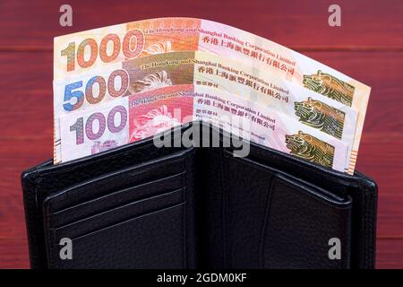 Denaro di Hong Kong - dollaro nel portafoglio nero Foto Stock