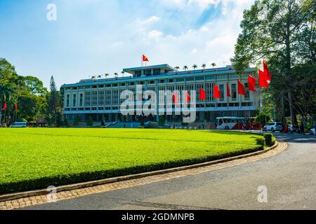 Ho Chi Minh City, Vietnam - CIRCA gennaio 2020: La facciata del Palazzo dell'Indipendenza, ho Chi Minh City, Vietnam; con diverse bandiere nazionali vietnamite aroun Foto Stock