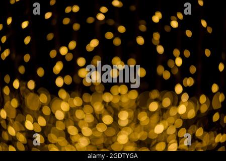 molti dei bokeh dal tubo della lampadina chiaro su una strada di notte che assomiglia alla luce della stella dorata di lusso in sfondo scuro Foto Stock