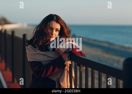 Giovane donna in camice a costa all'aperto Foto Stock