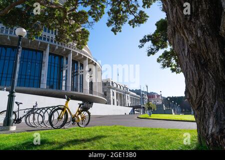 Biciclette al di fuori degli edifici governativi della Nuova Zelanda, tra cui un punto di riferimento circolare conosciuto come Beehive, Wellington. Foto Stock