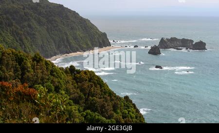 Formazioni rocciose lungo l'oceano, Knight's Point, Fox Glacier-Haast, Whataroa, West Coast Region, Isola del Sud, Nuova Zelanda Foto Stock