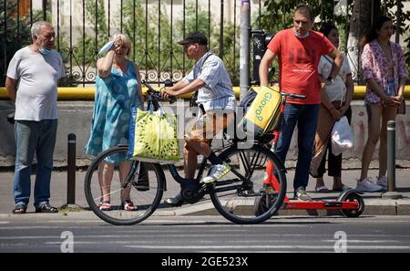 Bucarest, Romania - 12 agosto 2021: Un corriere di consegna del cibo di Glovo consegna il cibo a Bucarest, Romania. Foto Stock