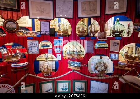 Neuharlingersiel, Germania. 05 agosto 2021. Nel Buddelschiffmuseum sono esposte navi modello. Dopo 50 anni, uno dei più antichi musei della Frisia orientale è sul punto di chiusura. Il museo è stato aperto nel 1971. Dopo la morte del fondatore, suo figlio ha preso il controllo della mostra, che è visto da circa 20,000 visitatori ogni anno. Landmann è ora alla ricerca di un successore per il suo museo presso l'Hotel Janssen a Neuharlingersiel. (To dpa 'Mini-Welten unter Glas: Buddelschiffmuseum sucht neuer Besitzer') Credit: Sina Schuldt/dpa/Alamy Live News Foto Stock