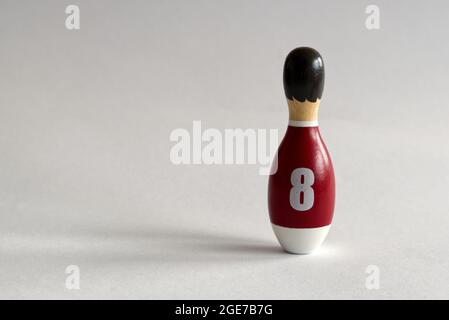 Retrovisione di un burattino in legno a forma di una spina da bowling con una maglia numero otto Foto Stock