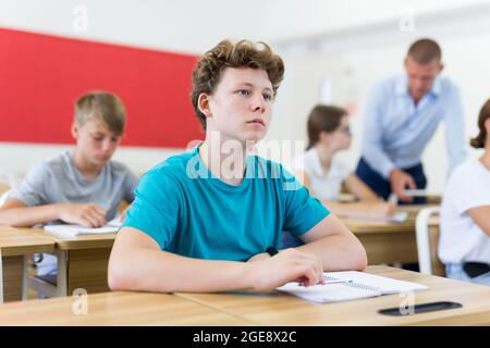 Lo studente stanco si è addormentato sulla scrivania in classe Foto Stock