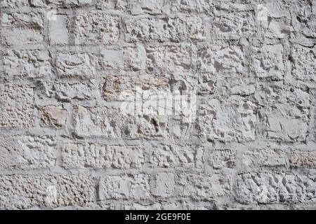 Parte di un muro di pietra, per lo sfondo o la trama. Foto Stock