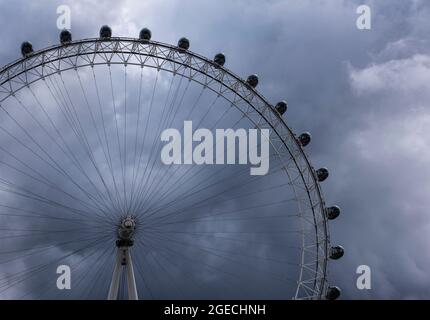 Guardando verso l'alto il London Eye attraverso le nuvole di tempesta, Londra, Inghilterra Regno Unito Foto Stock