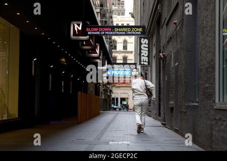 Melbourne, Australia, 3 agosto 2020. Una donna è vista camminare attraverso uno dei vicoli deserti di Melbourne durante il COVID-19 a Melbourne, Australia. Mentre Melbourne sperimenta il suo primo giorno di restrizioni di fase 4, insieme a un coprifuoco dalle 20:00 alle 5:00, il Premier Daniel Andrews ha annunciato oggi il piano di chiusura per tutte le attività, tranne quelle più essenziali, almeno per le prossime 6 settimane. Victoria ha registrato altri 429 casi COVID-19 e altri 13 decessi, portando il totale dei casi attivi degli stati a 6,489. Credit: Dave Hewison/Speed Media/Alamy Live News Foto Stock