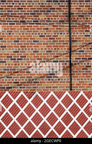 Una foto astratta di forme, colori, una recinzione, muro e fili in Queens, New York. Foto Stock