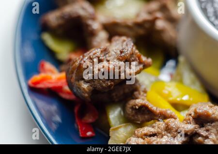 Strisce di manzo con peperoni misti e mangetout serviti con salsa di fagioli neri, pasto cinese Foto Stock