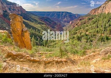 Una colonna rocciosa lungo il North Kaibab Trail con luminoso Angel Canyon sullo sfondo del Grand Canyon North Rim Arizona. Foto Stock