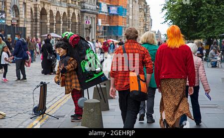 Tempo di Edimburgo, Scozia, Regno Unito. 20 agosto 2021. Giornata nuvolosa per il centro della città e per coloro che cercano un po' di divertimento dai vari festival della città. Nella foto: Abiti colorati che illuminano High Street all'Edinburgh Fringe Festival. Credit: Arch White/Alamy Live News Foto Stock