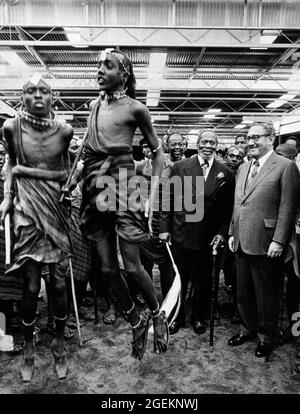 Apr 1976 - Nairobi, Kenya; Segretario di Stato degli Stati Uniti HENRY KISSINGER, a destra, in Kenya sorridendo mentre guarda una tradizionale performance dei guerrieri Massi. Il Dott. Kissinger è in Kenya per l'inizio del suo tour delle capitali africane. Kissinger ha incontrato il presidente JOMO KENYATTA, seconda a sinistra, al suo arrivo. Credit: Keystone Press Agency/ZUMA Wire/Alamy Live News Foto Stock