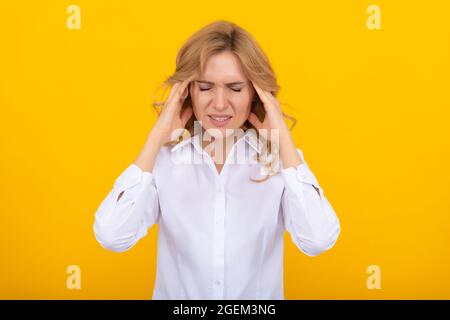 Gestire l'emicrania sul lavoro. Il capo della donna soffre di mal di testa. Attacco di emicrania. Mal di testa Foto Stock