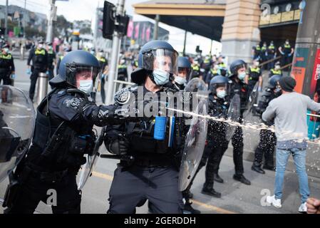 Melbourne, Australia. 21 agosto 2021. Gli ufficiali della squadra di riot usano lo spruzzo del pepe contro i manifestanti di anti-bloccaggio. Credit: Jay Kogler/Alamy Live News Foto Stock