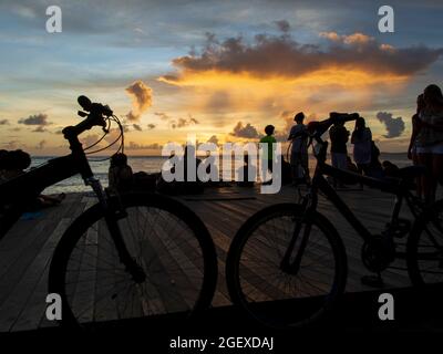 Salvador, Bahia, Brasile - 08 gennaio 2019: Silhouette di persone al molo di Porto da barra a Salvador (BA), con biciclette stazionarie. Foto Stock