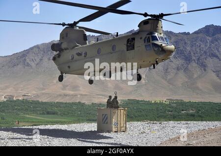 Un CH-47 Chinook si prepara a caricare un container a Chorah, Afghanistan, 12 maggio 2013. I Chinooks, volati da membri della Bravo Company, 2° Battaglione, 104° Regiment Aviazione della Guardia Nazionale dell'Esercito del Connecticut e della Pennsylvania , hanno svolto un ruolo vitale nella missione in Afghanistan dal loro arrivo nel dicembre 2012 effettuando missioni di riapprovvigionamento, retrogrado e pianificate. (STATI UNITI Foto dell'esercito di Sgt. Jessi Ann McCormick) Foto Stock