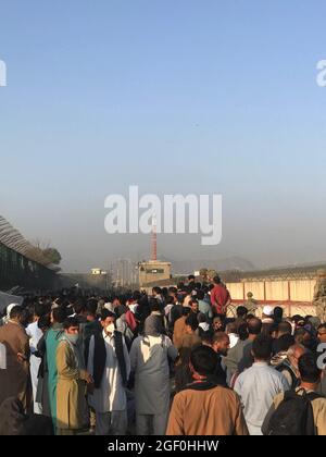 Kabul, Afghanistan. 22 agosto 2021. Gli afghani si riuniscono vicino ad una porta dell'aeroporto di Kabul, Afghanistan, 22 agosto 2021. Sette civili afghani sono stati uccisi in mezzo al caos vicino all'aeroporto di Kabul mentre la gente ha inghiottito la zona nella speranza di salire a bordo di un volo di evacuazione dopo l'acquisizione dei talebani dell'Afghanistan, ha detto domenica il Ministero della Difesa britannico. Credit: Rahmatullah Alizadah/Xinhua/Alamy Live News Foto Stock