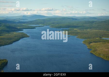 Vista di Eyriel alla natura selvaggia di Kiruna da elicottero con grande lago nel mezzo della foresta nell'estremo nord della Lapponia svedese con picchi più alti nel Foto Stock