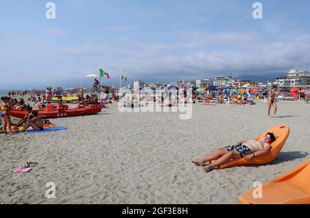 Versilia, Italia. 22 agosto 2021. Vista su una spiaggia in Versilia, Toscana, Italia, il 22 agosto 2021. La Toscana ha più di 400 km (250 miglia) di costa. La parte settentrionale di essa, denominata Versilia, ha un'ampia e lunga spiaggia di sabbia che va per chilometri da Marina di Carrara a Torre del Lago Puccini, punteggiando località di fascino come Forte dei Marmi, Marina di Pietrasanta, Viareggio. Centinaia di stabilimenti balneari coprono il mare, con le Alpi Apuane, una catena di montagne molto impressionante, sullo sfondo.(Photo by Elisa Gestri/Sipa USA) Credit: Sipa USA/Alamy Live News Foto Stock