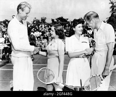 JUDY GARLAND e PAULETTE GODDARD giocando a Tennis con i giocatori professionisti di Tennis LESTER STOEFEN e BILL TILDEN ad un evento all'Hotel Ambassador di Los Angeles nel 1939 Pubblicità per Metro Goldwyn Mayer Foto Stock