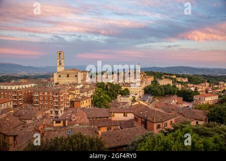 Italia, Provincia di Perugia, Perugia, nuvole sul centro storico al tramonto con la basilica di San Domenico sullo sfondo Foto Stock