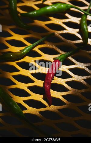 Foto dall'alto di peperoncini thailandesi su un tavolo giallo. Foto Stock