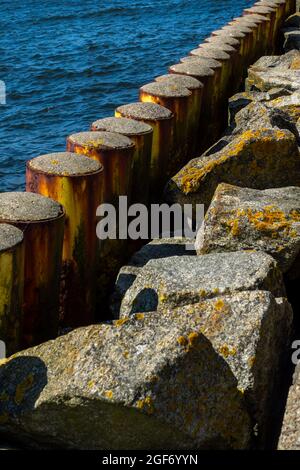 Pali di acciaio che proteggono la banchina del porto. Foto scattata in buone condizioni di illuminazione in una giornata di sole Foto Stock