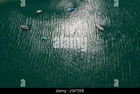 Colpo di drone, barca dall'alto al lago in controluce con riflessione d'acqua, Mondsee, Salzkammergut, Austria superiore, Austria Foto Stock