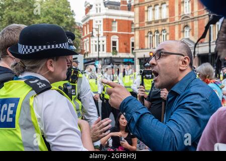 Londra, Regno Unito. 24 agosto 2021. Un uomo cerca di superare le linee di polizia e sostiene con gli ufficiali, durante la manifestazione. ‘la ribellione impossibile’ protesta contro il cambiamento climatico, il riscaldamento globale, che prevede di colpire la causa alla radice della crisi climatica ed ecologica e di chiedere al governo di cedere alle compagnie di combustibili fossili da parte della ribellione estinzione. Credit: SOPA Images Limited/Alamy Live News Foto Stock