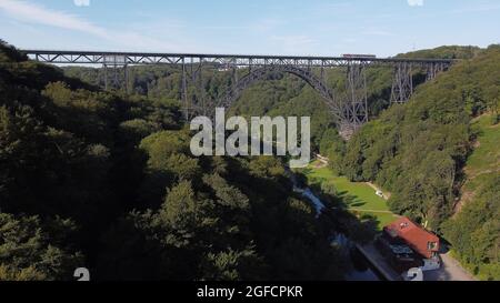 Solingen, Germania. 25 ago 2021. Il ponte ferroviario di Müngsten, un ponte a traliccio in acciaio, conduce su una valle del Wupper. La costruzione fu completata nel 1897 e fu chiamata 'Kaiser-Wilhelm-Brücke' fino al 1918. L'imponente struttura è la proposta della Renania Settentrionale-Vestfalia di un elenco di domande per i futuri siti del Patrimonio Mondiale della Conferenza dei Ministri della Cultura. Credit: David Young/dpa/Alamy Live News Foto Stock