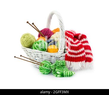 Palle di fili di lana per maglieria in cesto di vimini isolato su sfondo bianco. Foto Stock